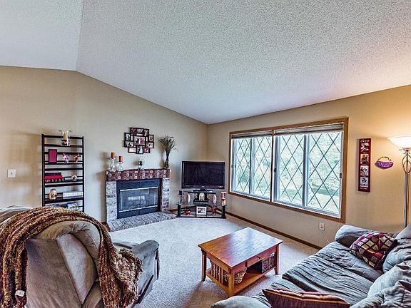 Spacious main level family room w/vaulted ceilings, fireplace, newer carpet and fresh paint!