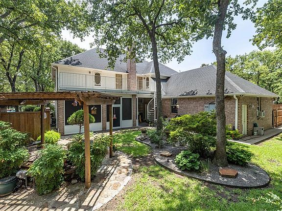 Backyard oasis with pergola over Koi pond, spiral staircase leading to balcony