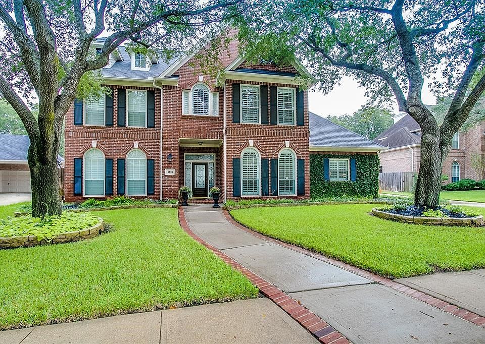 Sitting on a private cul-de-sac lot, 2606 Silent Spring Creek is nestled within the oak trees of the exclusive gated Cinco Ranch
