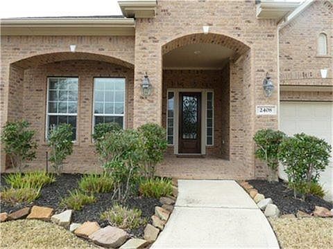 Welcoming Large Front Porch with decorative  Wrought Iron Entry Door.