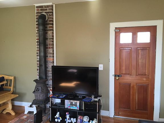 Door to private patio with small vintage woodstove.