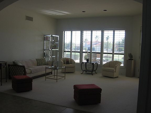 Enter to open foyer surrounded by living room, dining room and den/office. Plantation shutters throughout the house.