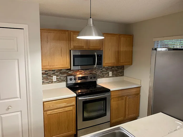 stainless steel appliances with ceramic top range and ample pantry.