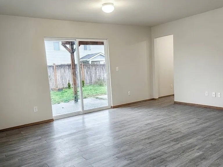 Large lower-level bonus room with sliding door to private backyard