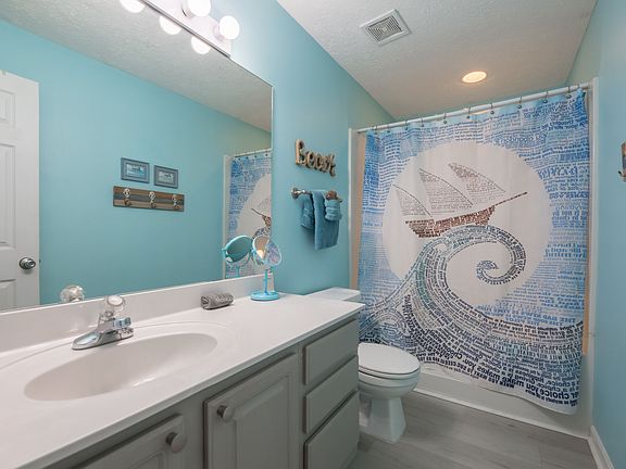 Bathroom: jetted tub, single sink, shower.