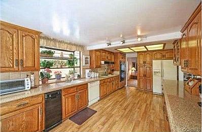 Expanded kitchen with Caesarstone counters and seating area