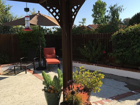 Backyard with patio cover/ opposite end of the patio is a la