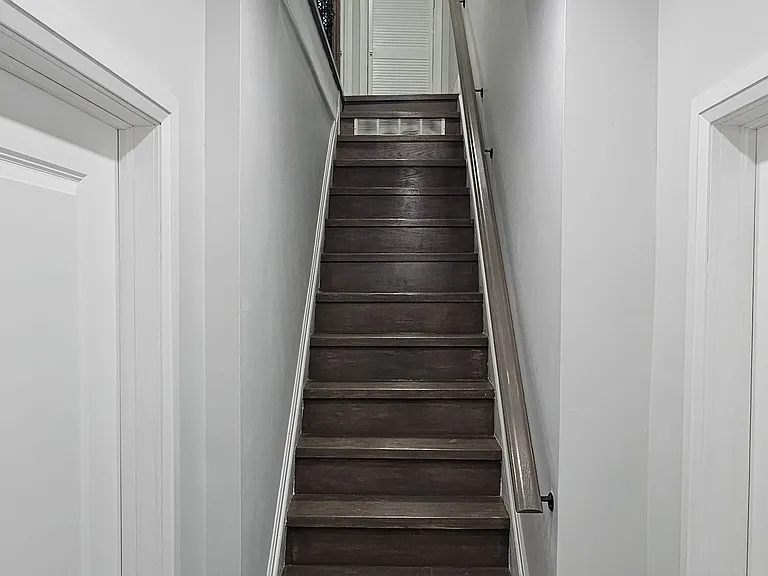Stairway to bedrooms + living room on the right