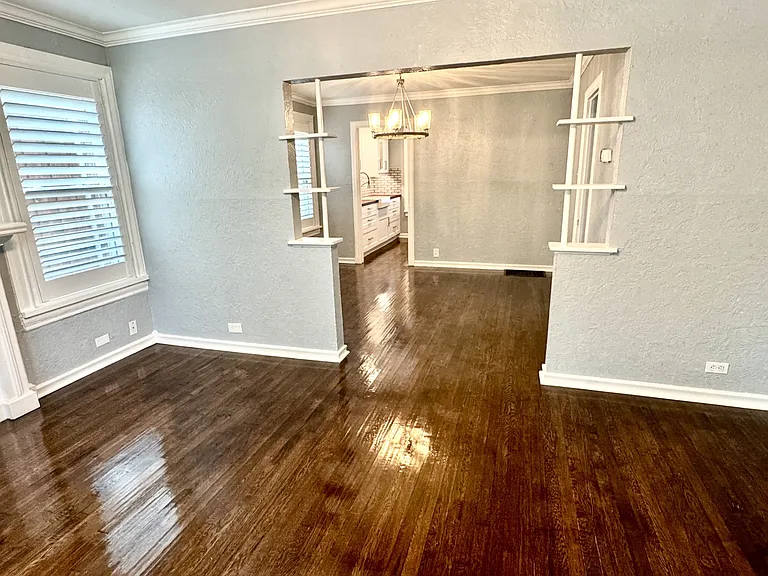 View from the living room, looking into the dining room and kitchen.