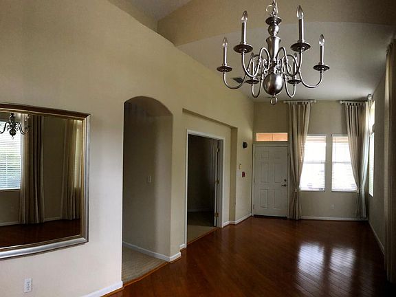 Dining room, living room, entrance to office/den and hallway.