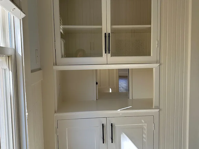 built-in cabinets with small pocket doors that open to the living space