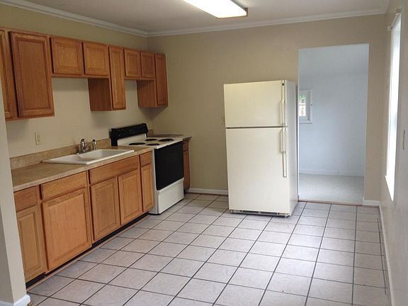 Kitchen with side laundry room with laundry hook ups