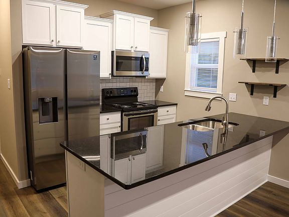 Kitchen with Side-By-Side Refrigerator, Range, Microwave, Dishwasher & Disposal