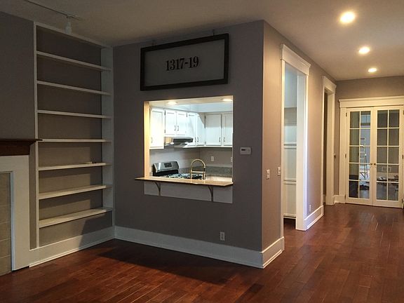 View from family room toward kitchen. Note built-in shelving
