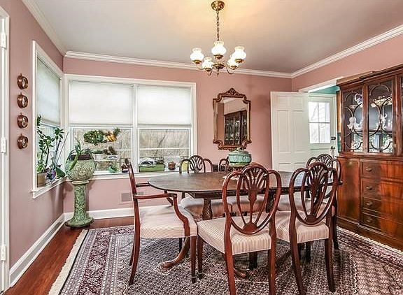 Formal Dining Room With Crown Moldings and Door to Patio