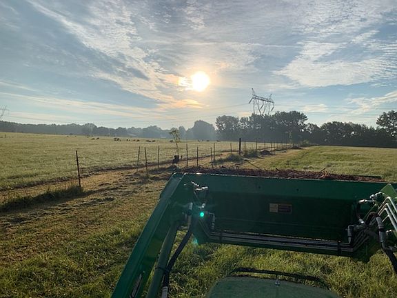 Sunrise over a tractor