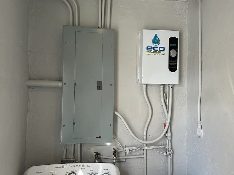 Laundry room. With new Tankless energy saving electric water heater.