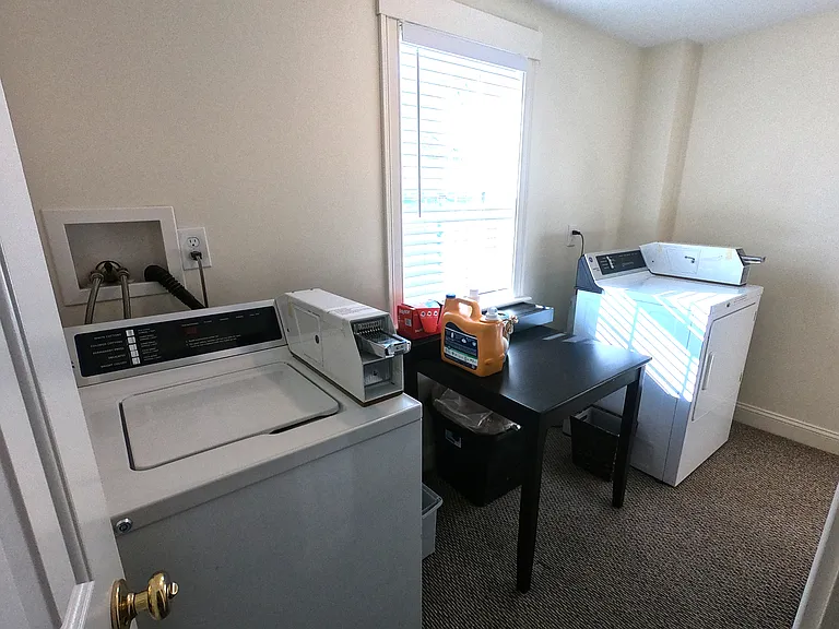 Shared laundry in the hallway for only Units 2 and 3.