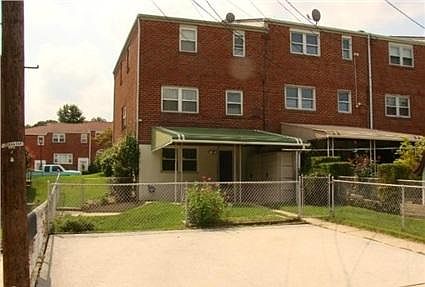Covered rear patio and 2 private parking spaces in the foreground