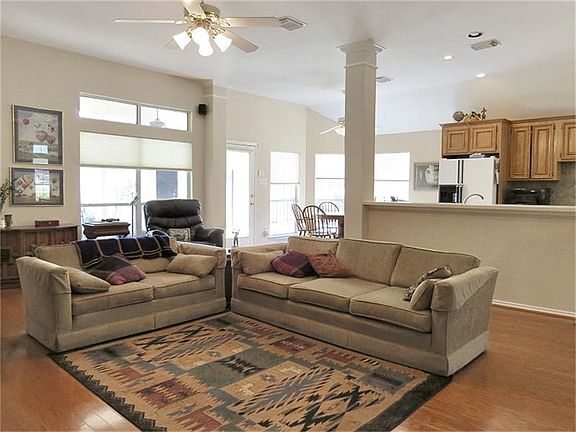 Open living room with hardwoods and easy access to kitchen.
