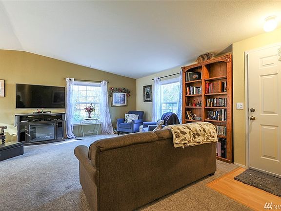 A warm and cozy living room greets you as you enter through the front door.
