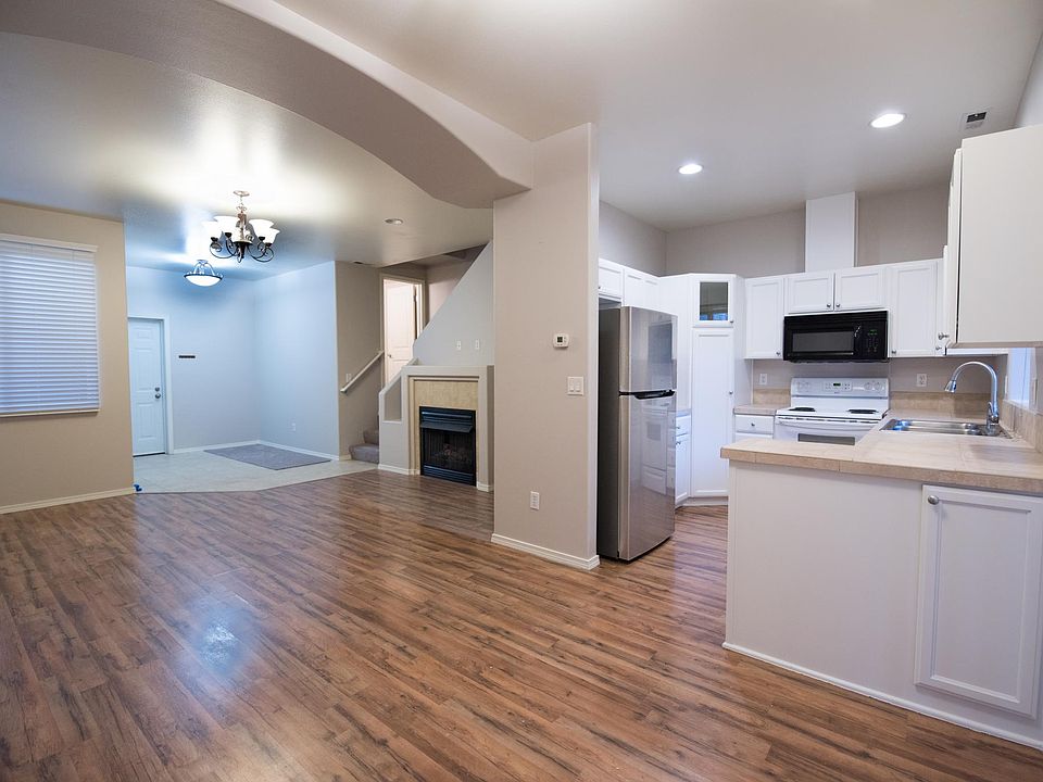 New LG Fridge and large living room with open kitchen.
