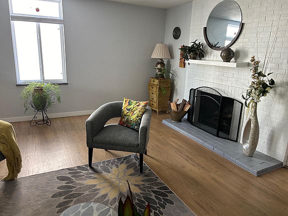 living room with wood burning fireplace