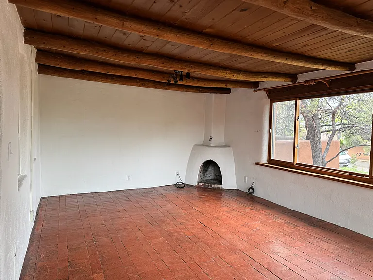 This is a photo of the living room of an adjacent unit with a similar layout to show the space without furniture.