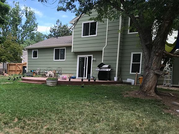 Backyard with patio, gardens, grass, fully fenced.The