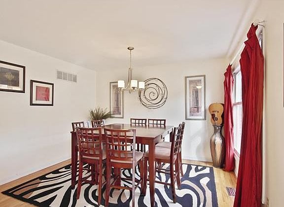 Beautiful hardwood floors in dining room, new light fixture and plenty of natural light