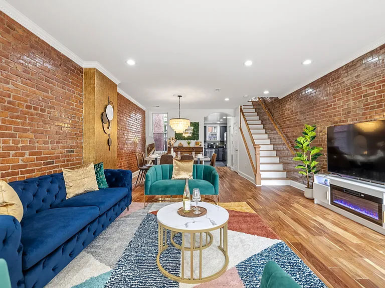 Living room with three sofas, TV, TV Stands