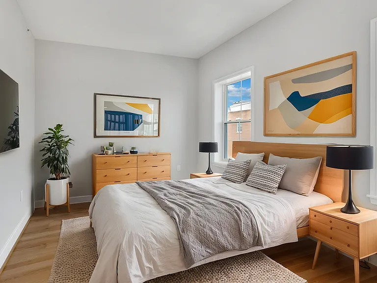 The larger of two bedrooms boasts two north-facing windows, a closet, and high ceilings.