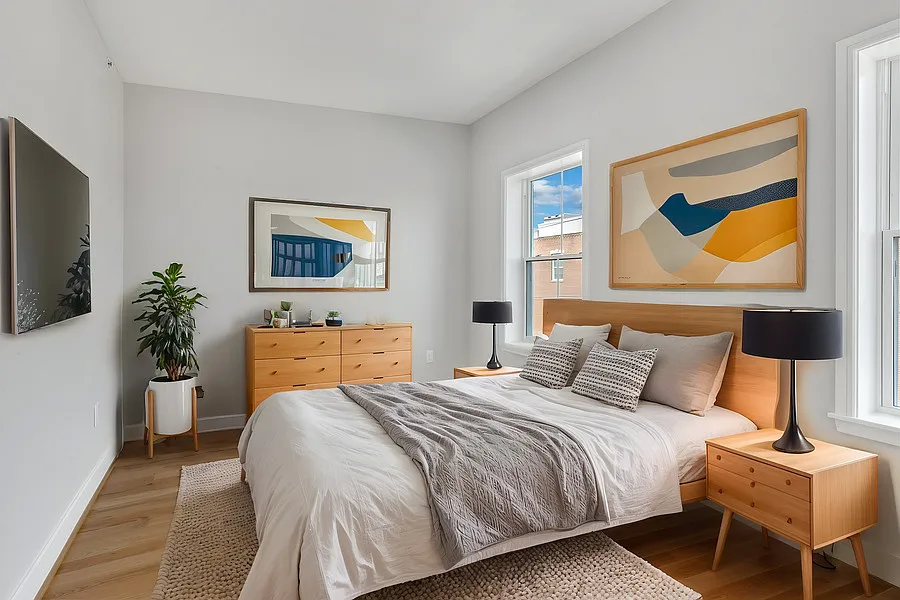 The larger of two bedrooms boasts two north-facing windows, a closet, and high ceilings.