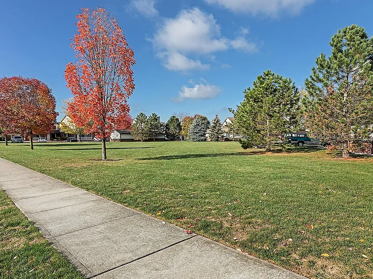 Stroll through peaceful green space shaded by mature trees _ just one of the ways Gateway Crossing gives you room to breathe.