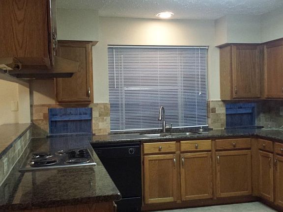 Granite countertops and travertine backsplash