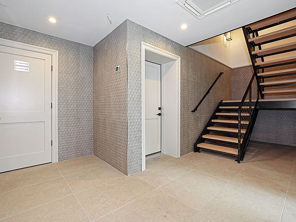 Main Floor Foyer with Staircase and Elevator to Residence