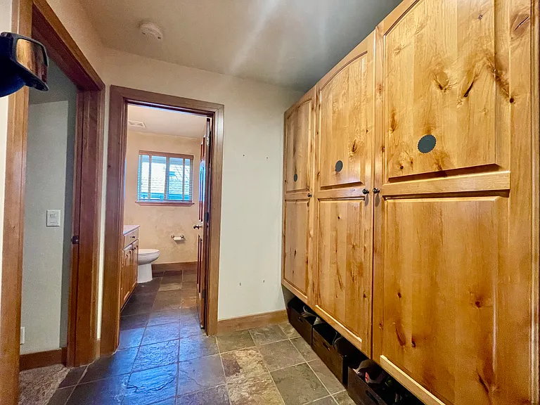 Four individual lockers in mud room at the entrance of garage for storage