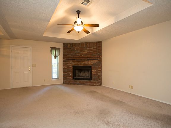 Brick Fireplace & Trayed Ceiling