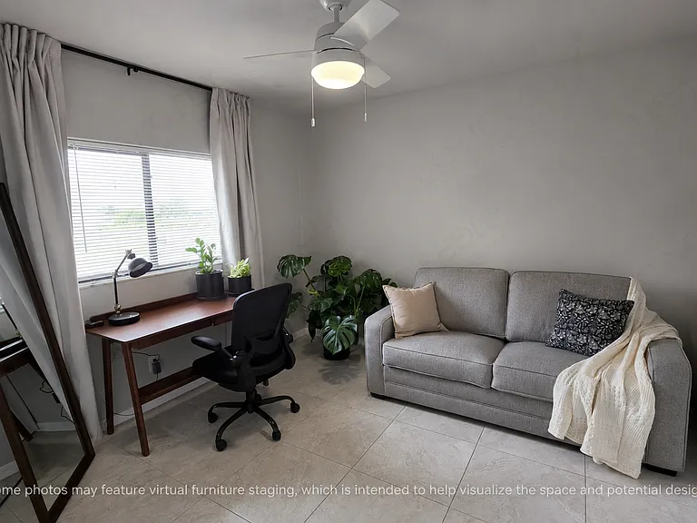 This room offers a comfortable, well-lit space that continues the home's clean, modern aesthetic. It's a versatile room perfect for guests, a home office, or a peaceful third bedroom