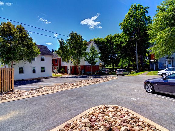 Additional parking is available for rent. There is also a yard under the trees in the center of the picture for tenants to use.