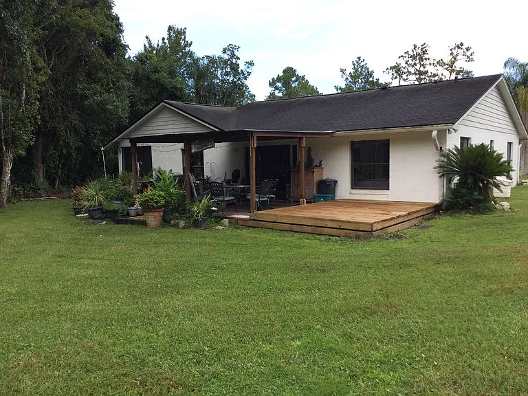 Roofed deck with shared propane grill and new deck extension