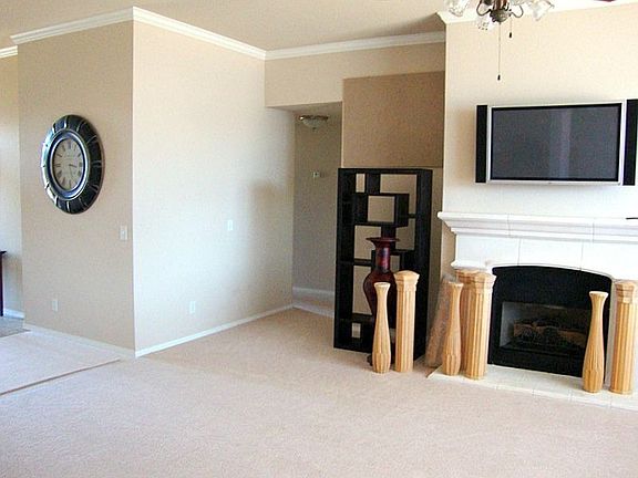 Living room with stone fireplace and gas logs