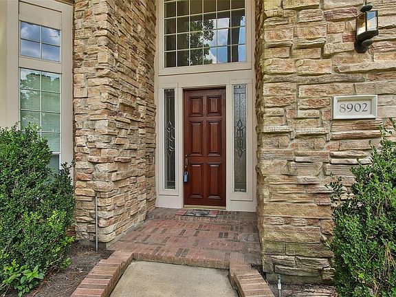 The beautiful wood front door opens to a breath taking 2-story entrance.