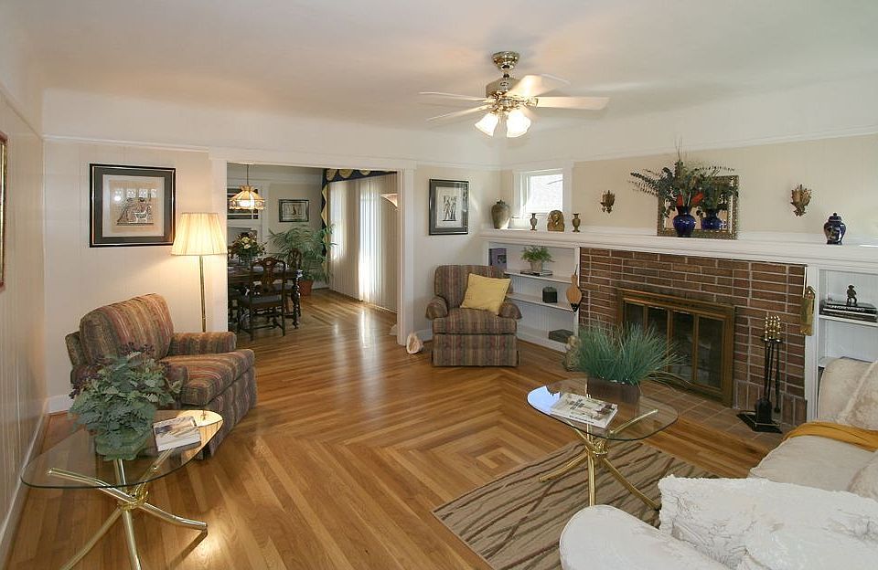 Living Room with wood burning fireplace and built shelving