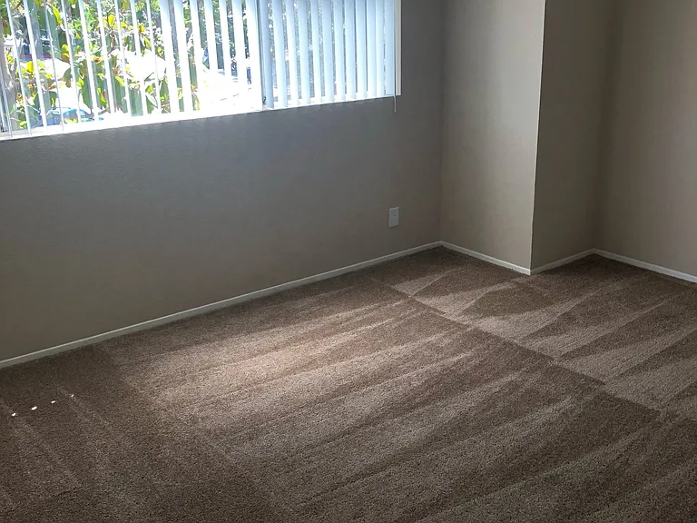 Roomy bedroom with great natural light and views at Grande Vista Apartments.