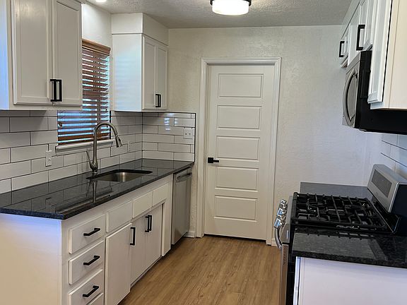 Bright kitchen with granite counter tops, SS appliances. Gas Stove, microwave, and dishwasher.