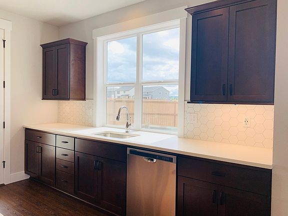 Kitchen sink, dishwasher and more storage cabinets.