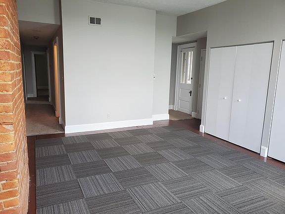 Living/dining area with hallway to bath and bedrooms.