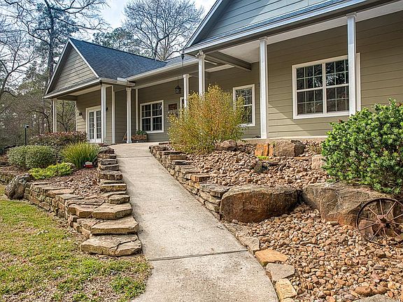 The front elevation has been meticulously planned for low maintenance. It is absolutely gorgeous, and even has a a weeping rock waterfall to greet you and your guests!