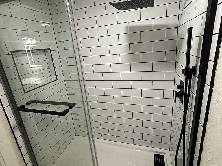 Upstairs shower with glass enclosure